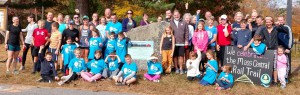 Most of the runners posing at the historic marker for the New Braintree train station, part of the Mass Central Rail Trail