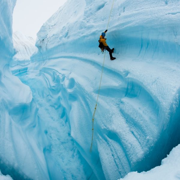 Adam LeWinter ice climbing in Survey Canyon, Greenland